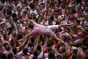 A reveller gets carried in the air by the crowd during the start of the San Fermin Festival in Pamplona