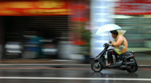 Man-on-a-scooter-in-the-rain