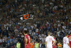 Albanian flag is flown over the pitch during the Euro 2016 Group I qualifying soccer match between Serbia and Albania at the FK Partizan stadium in Belgrade