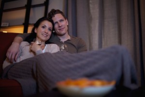 Couple cuddling on the couch.